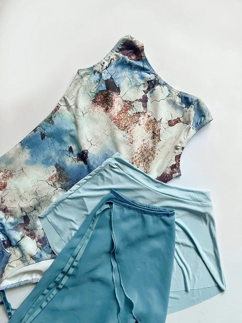 Leotard in blue, white and bronze abstract pattern. modern, cool different from The Collective Dancewear collaboration with Ballet Skirts By Lucinda. Chloe Keneally photographed by Szabrina Biro