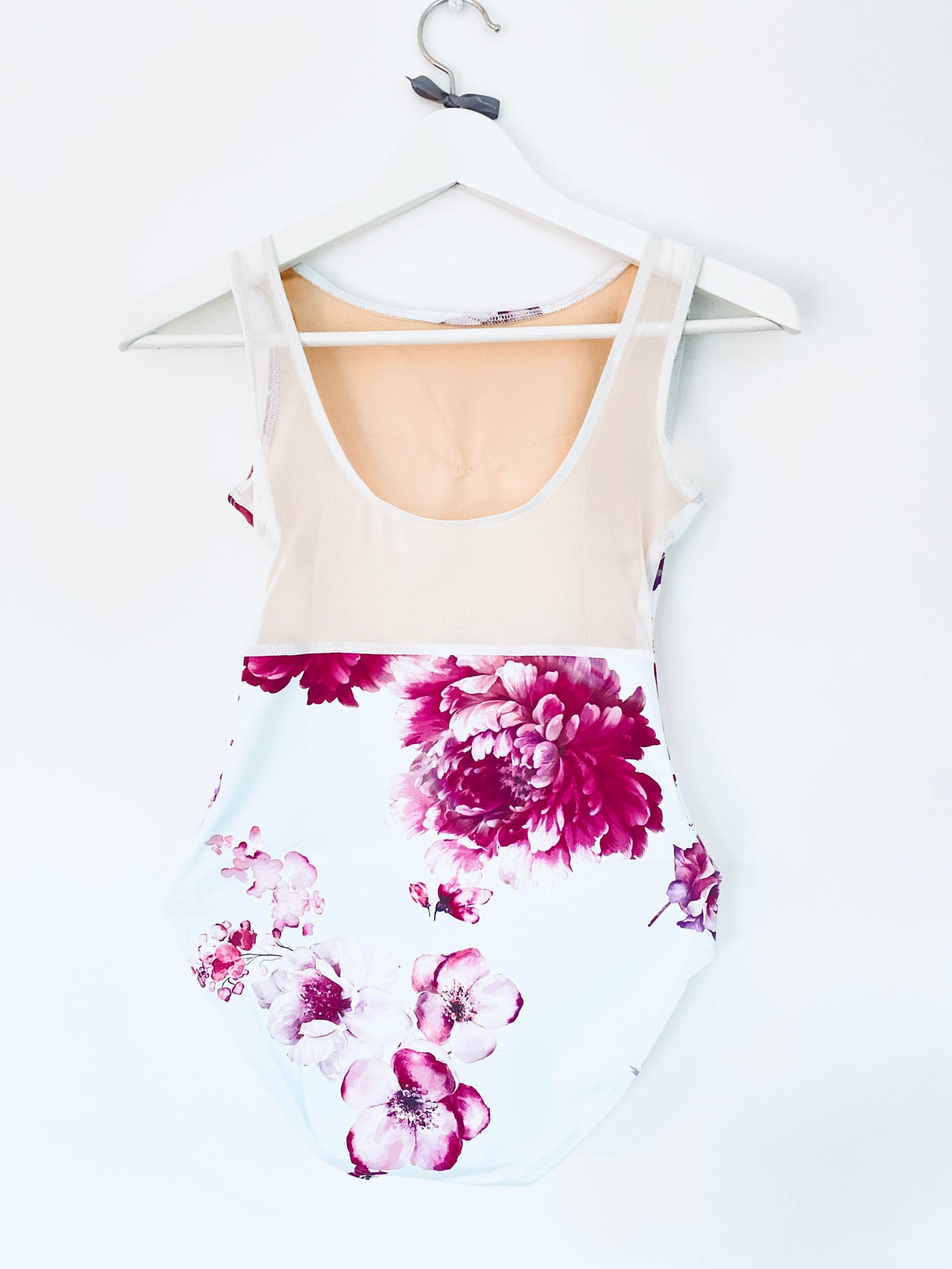 Leotard in pale blue with burgundy flower pattern from The Collective Dancewear