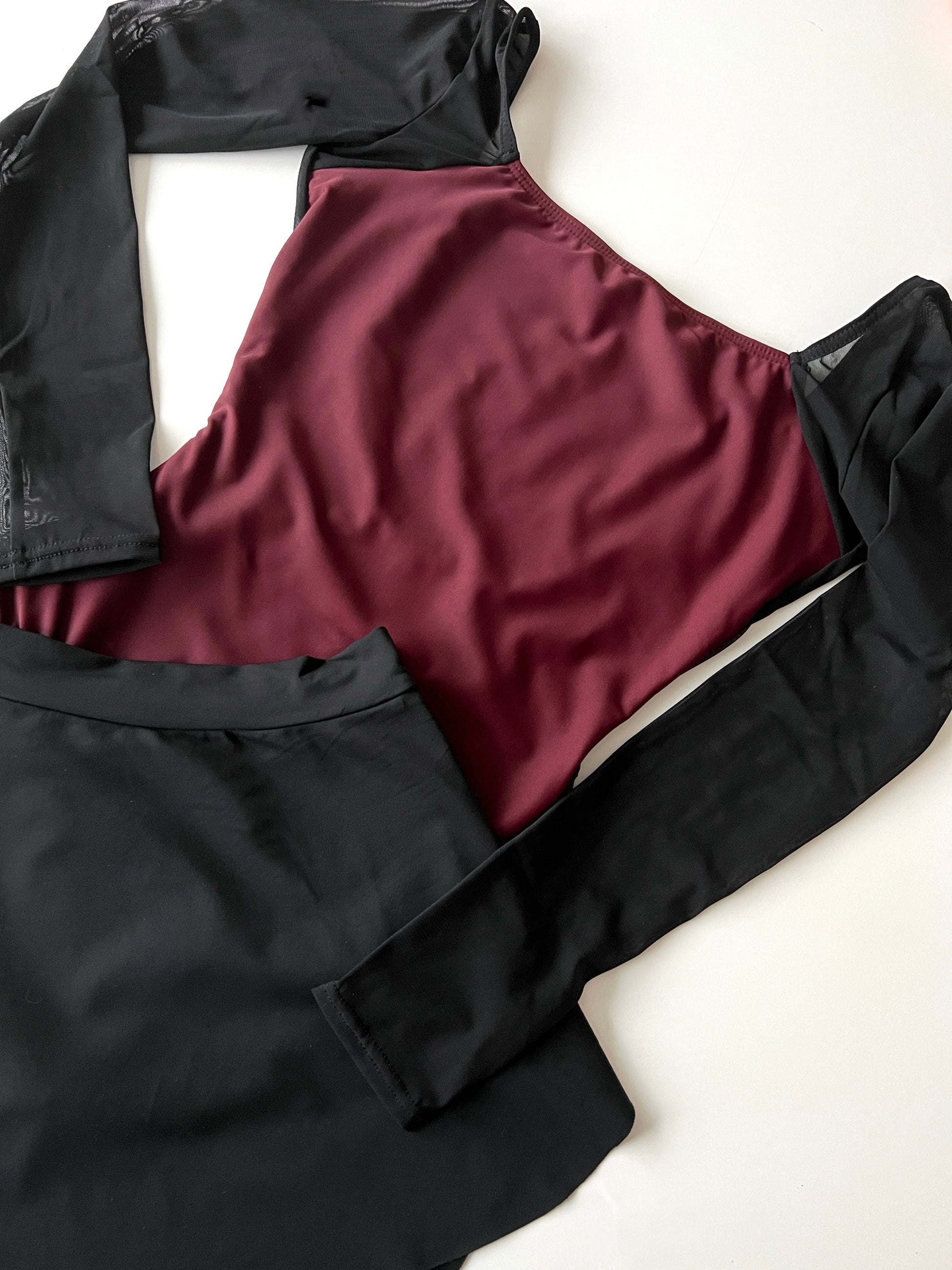 Margaux long sleeve leotard in maroon, red vine with black from The Collective Dancewear with black sab skirt