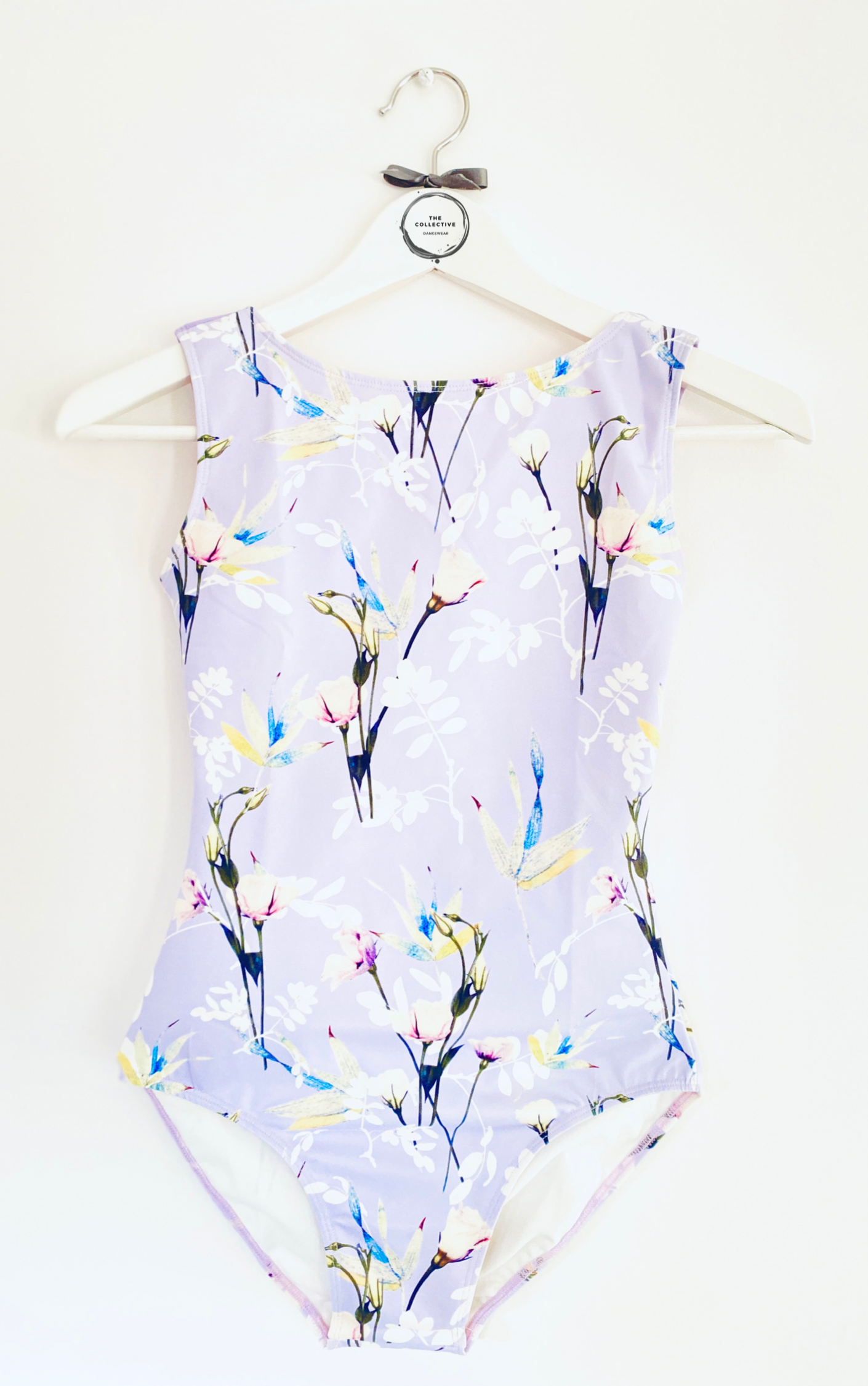 Sleeveless tank leotard with meadow flower pattern on a lilac background from The Collective Dancewear