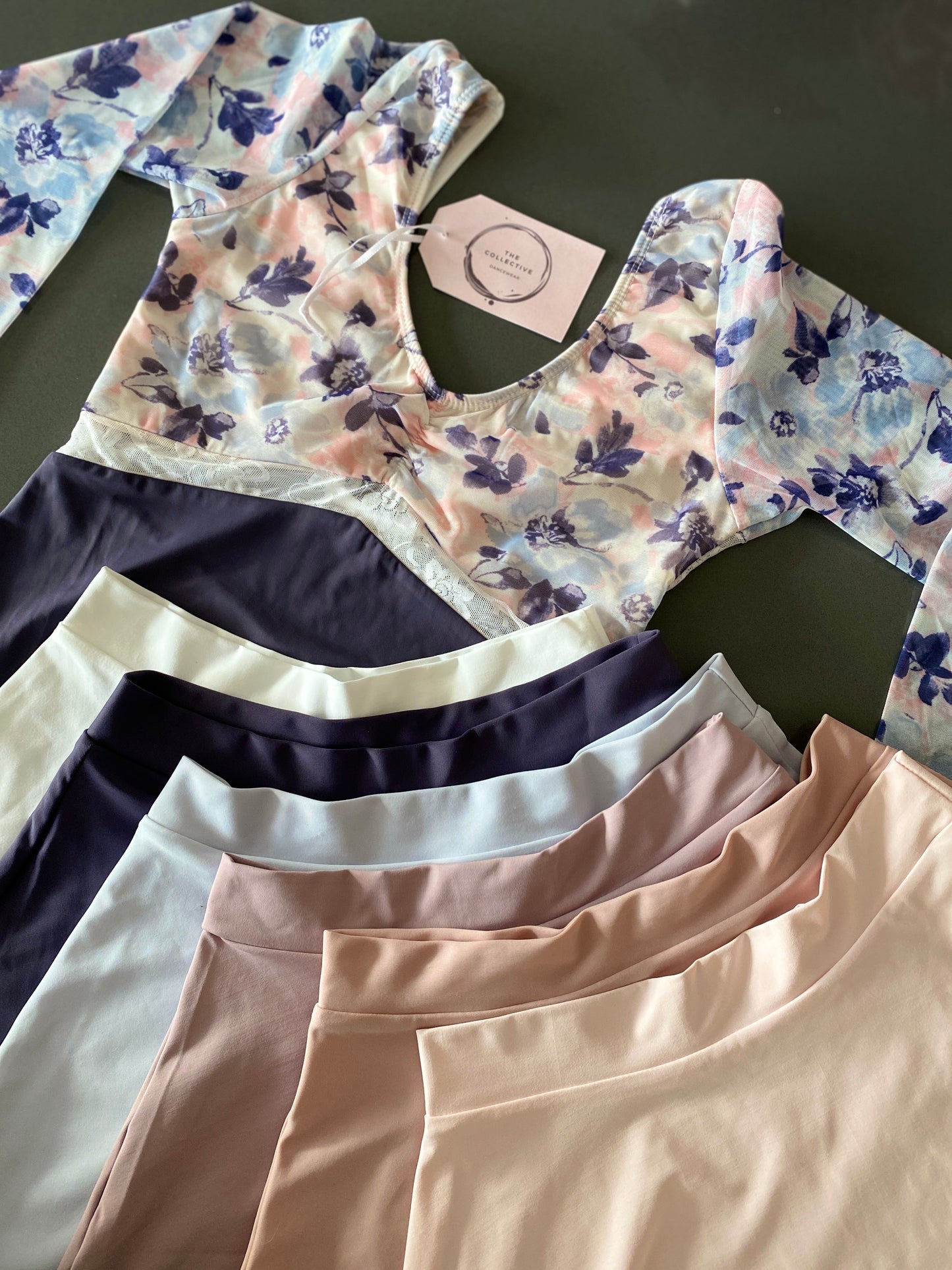 Floral plum leotard with a deep lace back and long sleeves from the Collective Dancewear with matching skirts in several colours such as white, plum, light blue, lilac, dusky pink and light pink