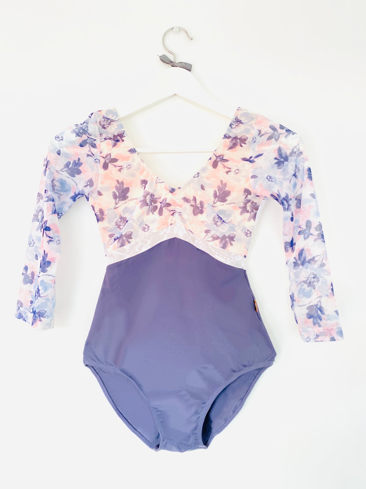 Floral plum leotard with a deep lace back and long sleeves from the Collective Dancewear