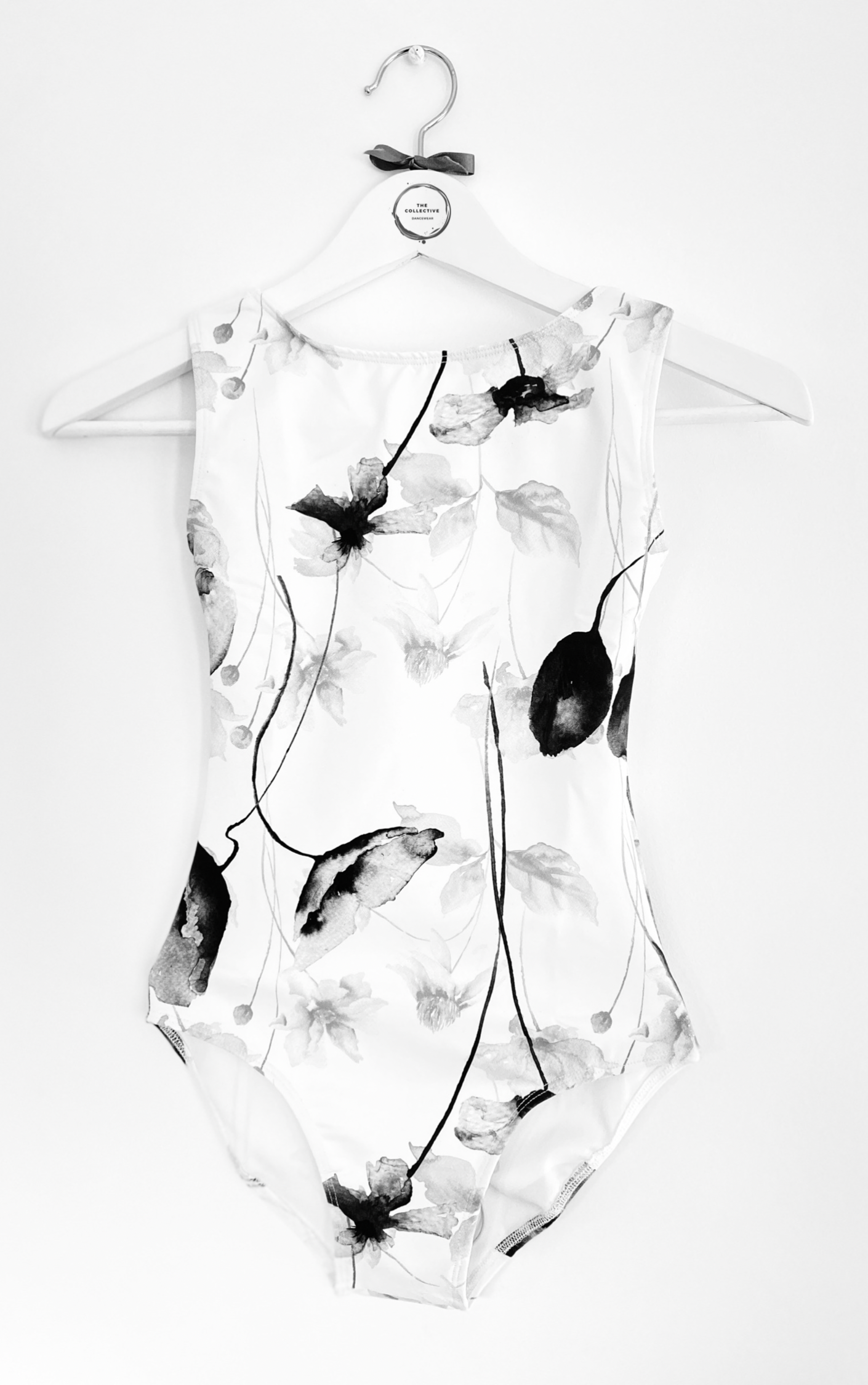 Sleeveless tank leotard with monochrome poppy pattern on white body from The Collective Dancewear