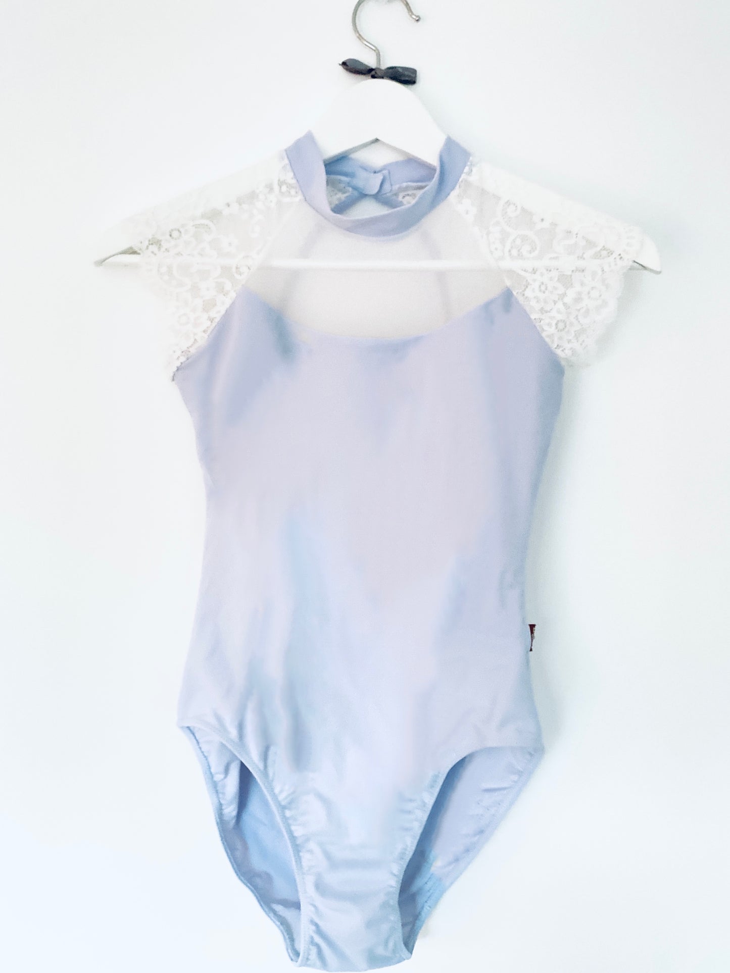 Beautiful leotard in pale blue with laced cap sleeves in white and a high neck from The Collective Dancewear